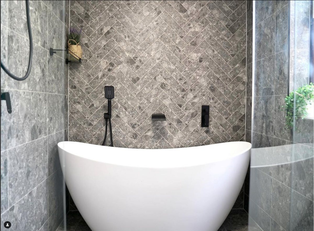 Subway tiling with a herringbone tiled feature wall