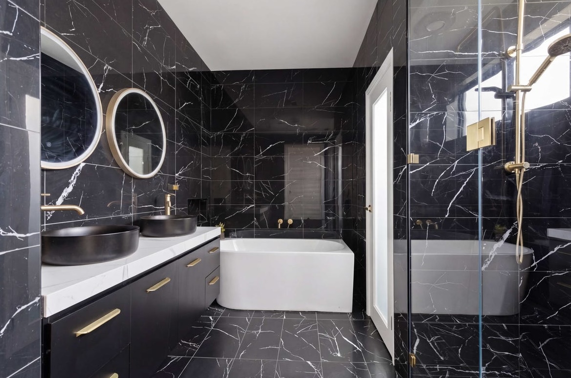 Black marble bathroom tiled floor to ceiling