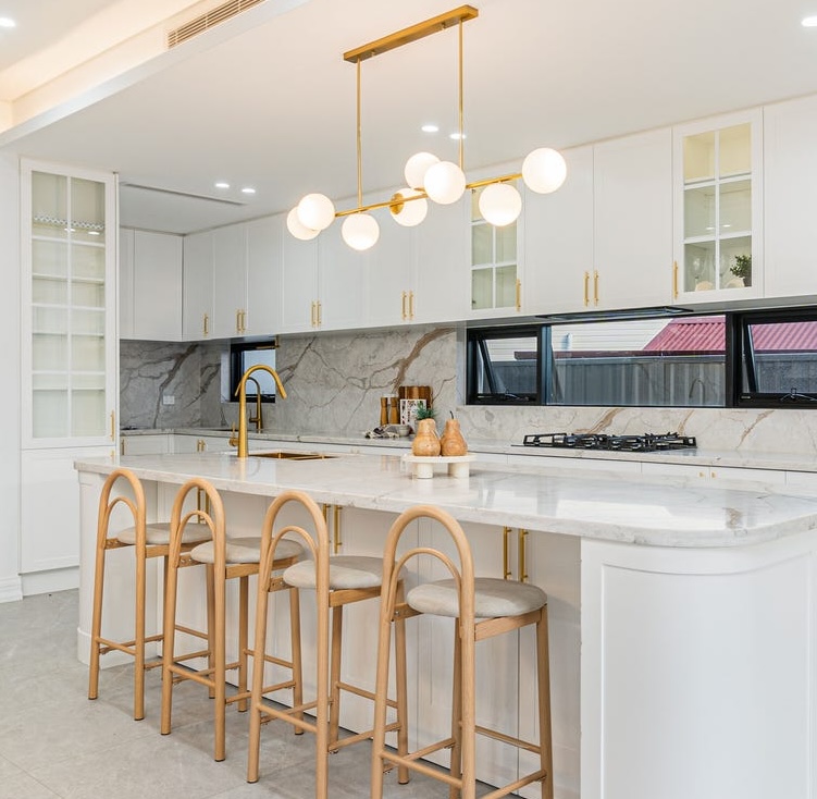 Luxury package kitchen renovation with a stone waterfall island